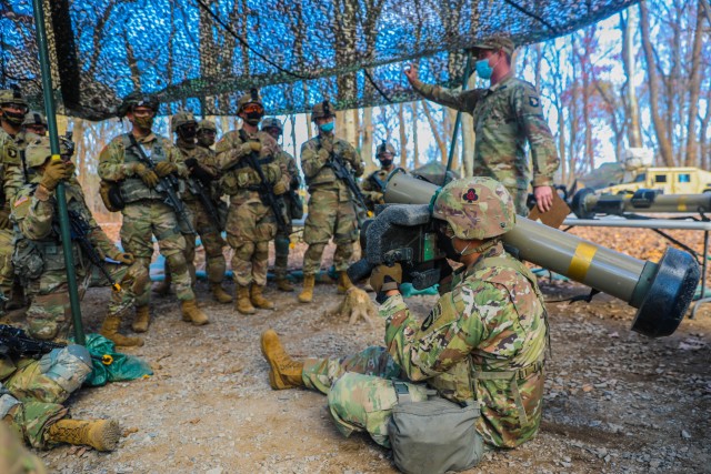 Soldiers from 1st Brigade Combat Team “Bastogne”, 101st Airborne Division (Air Assault), gather around a Soldier demonstrating the proper use of a Javelin Nov. 20 at the Expert Infantrymen Badge and Expert Soldier Badge testing site on Fort Campbell, Kentucky. 738 candidates across the brigade train to earn their EIB and ESB proving their mastery of the fundamentals and basic Soldier skills within their profession. U.S. Army photo by Sgt. Lynnwood Thomas