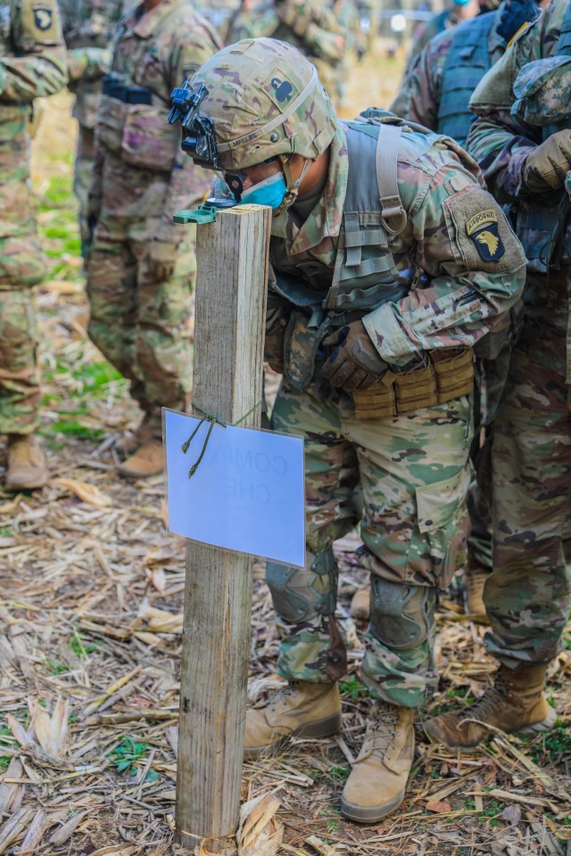 U.S. Army Spc. Rogelio Mireles, infantryman, 1st Battalion, 327th Infantry Regiment “Above the Rest”, 1st Brigade Combat Team “Bastogne”, 101st Airborne Division (Air Assault), peers through his compass and gains an azimuth prior to...