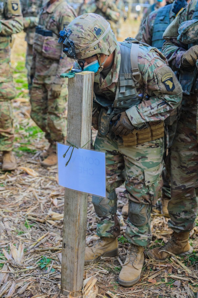 U.S. Army Spc. Rogelio Mireles, infantryman, 1st Battalion, 327th Infantry Regiment “Above the Rest”, 1st Brigade Combat Team “Bastogne”, 101st Airborne Division (Air Assault), peers through his compass and gains an azimuth prior to executing land navigation training at the Expert Infantry Badge training Nov. 20 at  the Expert Infantrymen Badge and Expert Soldier Badge testing site on Fort Campbell, Kentucky. 738 candidates across the brigade train to earn their EIB and ESB proving their mastery of the fundamentals and basic Soldier skills within their profession. U.S. Army photo by Sgt. Lynnwood Thomas