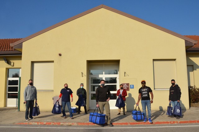 Members of Better Opportunities for Single Soldiers program pose for a picture before leaving the Spiritual Life Center heading to Villaggio Army Family Housing to deliver Thanksgiving to-go meals Nov. 26, 2020. They took part in the event providing this service to approximately 20 quarantined Soldiers and family members by lending a hand and bringing a taste of home to the community.