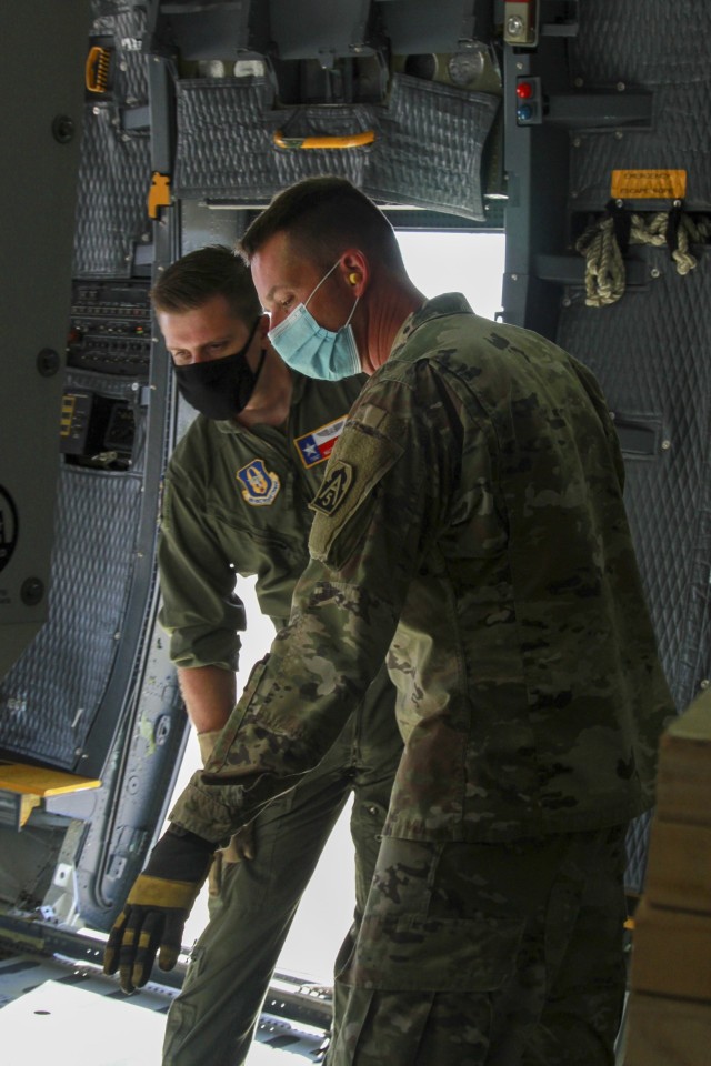 Lt. Col. Jeremy Gottshall, U.S. Army North’s Task Force 51’s logistic officer in charge, right, talks with U.S. Air Force Tech Sgt. Matt Legendre, a loadmaster assigned to the 68th Airlift Squadron, during the unit’s Level II Deployment Readiness Exercise (DRE), at Joint Base San Antonio Lackland Kelly Field Annex, Texas, Nov. 20, 2020. This exercise enhances the unit’s deployment readiness while maintaining USARNORTH’s forward capability in preparation for the 2021 hurricane season.