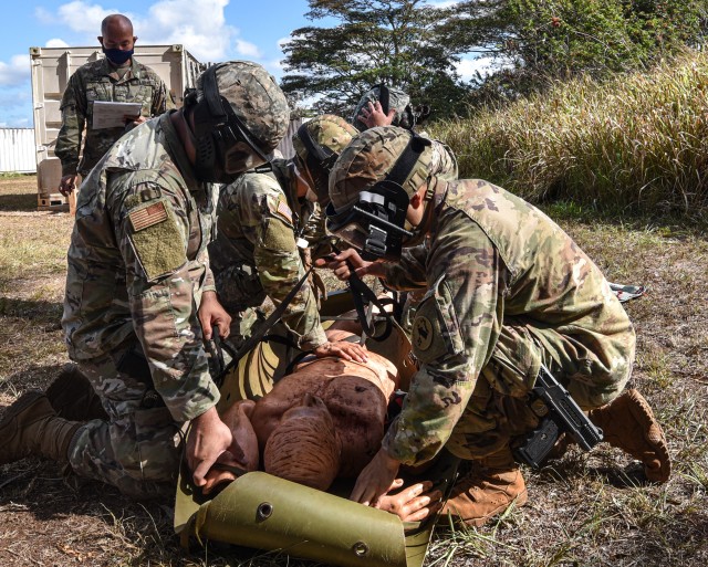 Joint Operations exercise participants stabilize an injured patient before evacuation and transportation.