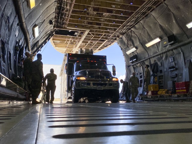 Soldiers assigned to U.S. Army North’s Task Force 51 and Airmen assigned to the 68th Airlift Squadron load the Sentinel, otherwise known as ARNORTH’s mobile command post, during the unit’s Level II Deployment Readiness Exercise (DRE), at J...