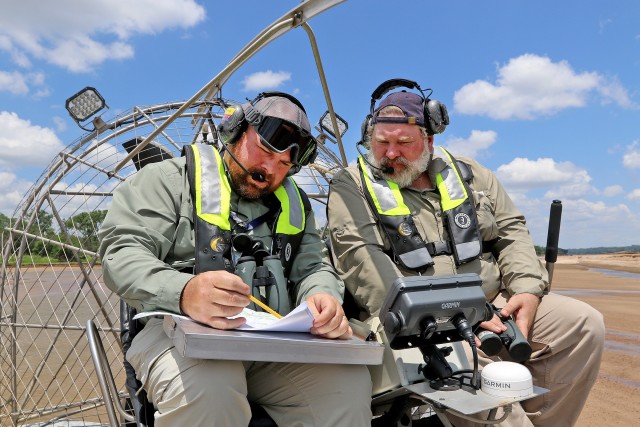 Tulsa District Biologist Jason Person (left) reviews data with Biologist Stacy Dunkin while conducting Interior Least Tern surveys on a sand bar in the Arkansas River July 7, 2020.  The U.S. Army Corps of Engineers, Tulsa District is responsible...