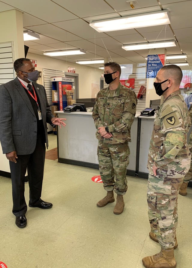 Eddie Banner, the Executive Postmaster of Brooklyn, left, discusses the post office’s reopening with Col. Craig Martin, Fort Hamilton Garrison Commander, and Garrison Command Sgt. Maj. Michael McCabe, Nov. 23, 2020. 