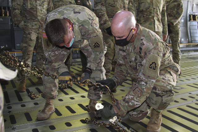 Col. Charles Brundrett, U.S. Army North’s Task Force 51’s operations officer, right, and Lt. Col. Jeremy Gottshall, U.S. Army North Task Force 51’s logistic officer in charge work together to chain down a vehicle, during the unit’s Level...