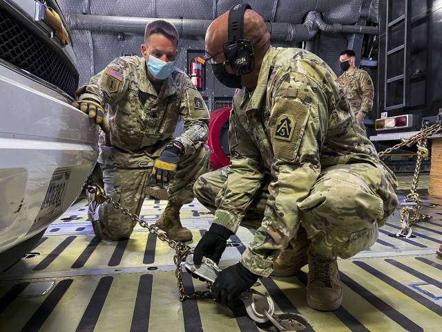 Staff Sgt. Whitfield Leach, U.S. Army North’s Task Force 51’s aide-de-camp, right, tightens down chains attached to an emergency response vehicle as Lt. Col. Jeremy Gottshall, U.S. Army North’s Task Force 51’s logistic officer in charge,...