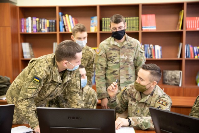 2nd Lt. Christopher Zolner and 2nd Lt. Anton Hopkins speak English with Armed Forces of Ukraine cadets during a course at the Ukrainian National Army Academy in Lviv, Ukraine Nov. 26. (Photo by U.S. Army Cpl. Shaylin Quaid)