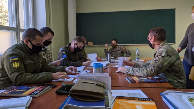 2nd Lt. Christopher Zolner and Cpt. Candace White speak English with Armed Forces of Ukraine cadets in the English Club at the National Army Academy in Lviv, Ukraine Nov. 26. (Photo by U.S. Army Cpl. Shaylin Quaid)