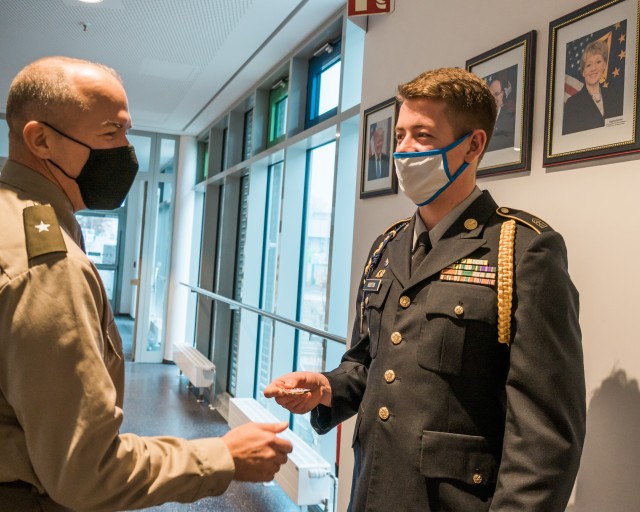 WIESBADEN, Germany-Brig. Gen. Jed Schaertl hands Sam Houston, senior, a coin in appreciation for the leading the school tour.