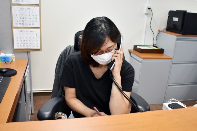 A member of the customer service department, operations and maintenance division, Directorate of Public Works, U.S. Army Garrison Japan, takes a service call at Camp Zama, Japan, June 29. Residents of the trial Army maintenance website should still call customer service for emergency calls.