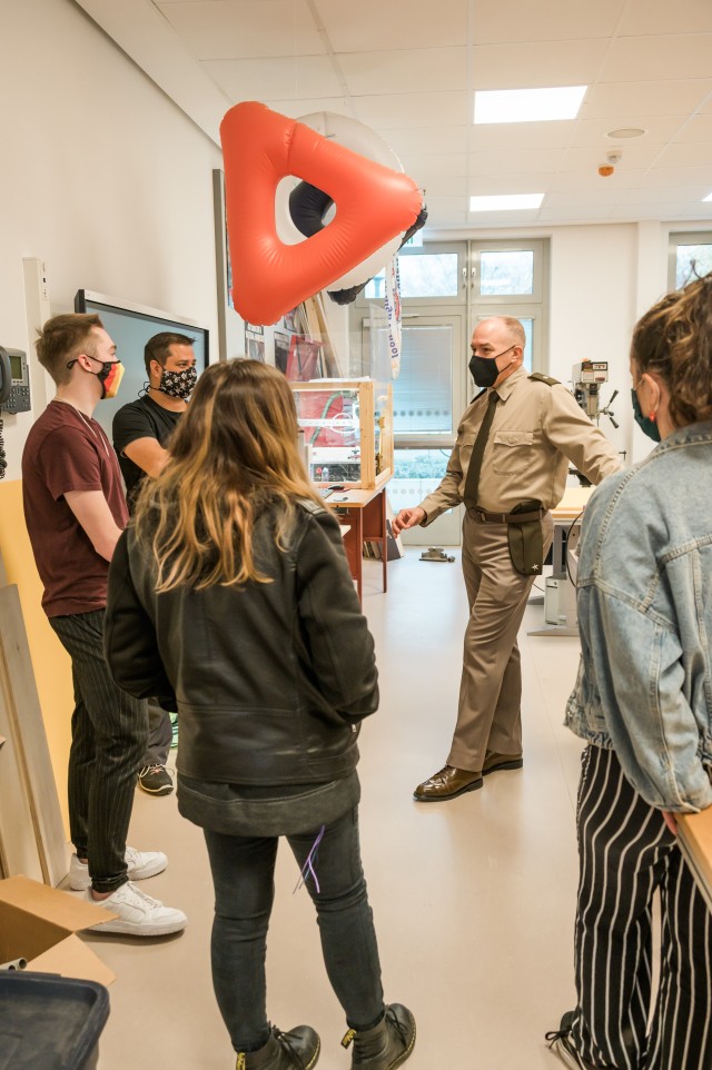WIESBADEN, Germany-Brig. Gen. Jed Schaertl asks Brian Barnes, technology teacher, about the use of the wood shop machinery in the STEM wing of Wiesbaden High School.