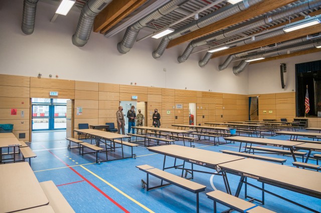 WIESBADEN, Germany-Dr. Heather Ramaglia, principal, and Sam Houston, senior, explain to the general how lunchroom seating and clean-up procedures have changed as a result of COVID-19.