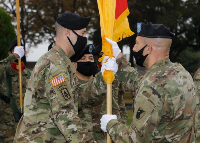SAGAMIHARA, Japan – Col. Matthew W. Dalton (right), 38th Air Defense Artillery Brigade commander, passes the brigade colors to Command Sgt. Maj. Kellen C. Rowley (left), incoming 38th ADA senior enlisted advisor, during an assumption of responsibility ceremony at Sagami General Depot Nov. 25. Pacific Guardians welcomed a new command sergeant major on Thanksgiving Eve, culminating with a brigade-wide celebration. (U.S. Army photo by Mimoko Shindo, U.S. Army Garrison Japan Public Affairs)