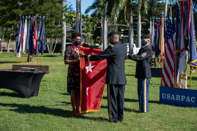 Command Sgt. Maj. Scott A. Brzak, U.S. Army Pacific’s command sergeant major; holds the 2-Star flag for Maj. Gen. Timothy M. McKeithen, deputy commanding general-Army National Guard and his wife, Simone, to case the colors during McKeithen’s retirement ceremony Dec. 1 held at Historic Palm Circle, Fort Shafter, Hawaii.  McKeithen served over 34 years of service in the U.S. Army.  (U.S. Army photo by Sgt. 1st Class Monik Phan)