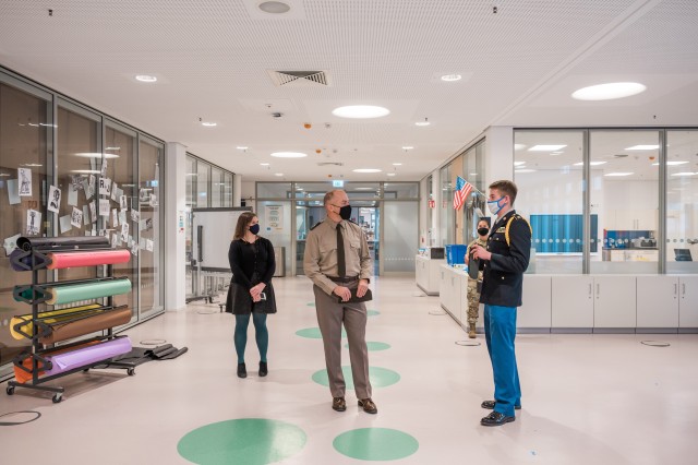 WIESBADEN, Germany-Senior Sam Houston explains to Brig. Gen. Jed Schaertl how the neighborhood classroom concept allows for flexibility with space and instruction.