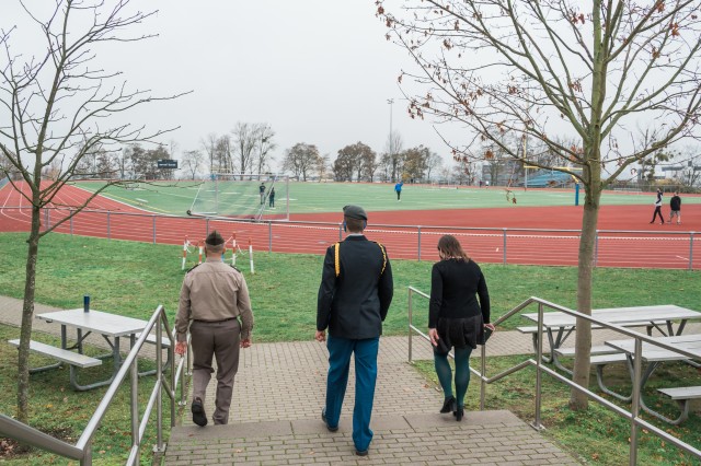 Brig. Gen. Jed Schaertl examines the athletic fields at Wiesbaden High School with Dr. Heather Ramaglia, principal, and Sam Houston, senior and S3 Sgt. Maj.  of the JROTC.