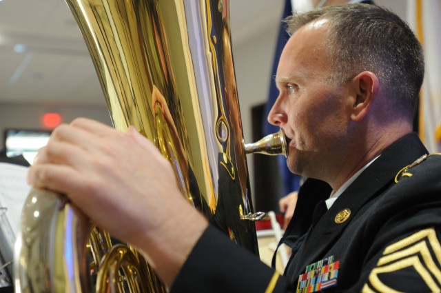 U.S. Army Reserve Sgt. 1st Class Jason Butler, a tuba player with the 380th Army Reserve Band, warms up by playing scales before the band’s performance at the 64th annual Commonwealth’s Veterans Day Ceremony at the Virginia War Memorial in...