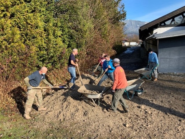 Volunteers shovel gravel