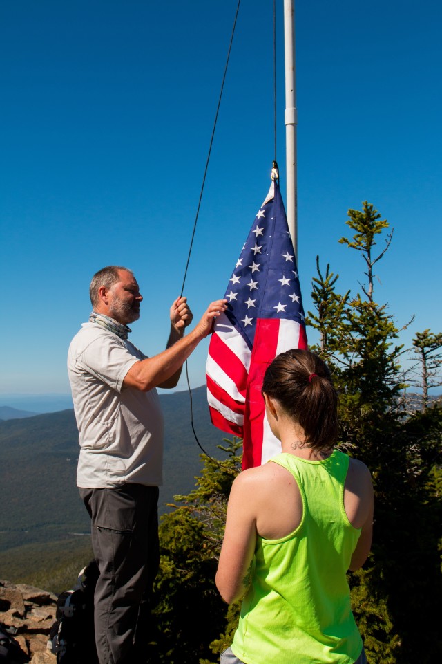 Members of Fort Devens RFTA and their family and friends joined 48 other groups across New Hampshire in a September 11th Memorial Hike. This hike is to honor those that lost their lives with a tribute: by flying the American flag atop all 48 four-thousand foot and higher mountains in New Hampshire. After a strenuous hike to the top of Mt. Flume we flew the flag for 2 hours and in the distance could see the flag atop Mt. Liberty.