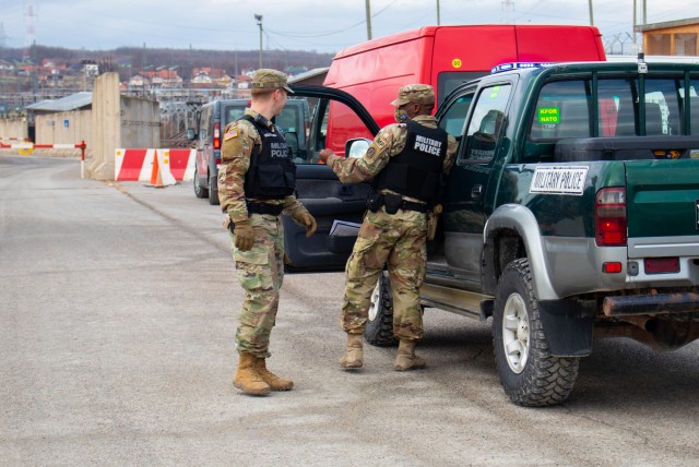 U.S. Army Reserves Spc. Nyriq King, a vehicle accident investigator with the 423rd Military Police Company out of Long Island, New York, conducts a traffic stop during a routine patrol at Camp Bondsteel, Kosovo, on Dec. 3, 2020. Traffic accident...
