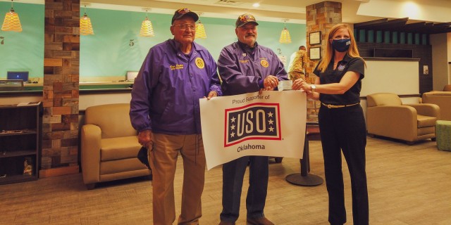Jennifer Kirby, the executive director of the Fort Sill USO stands with the adjutant of the Mount Scott Chapter 602 MOPH, Bruce Dwyer and Dan Eppler a life member of the Military Order of the Purple Heart with a donation to the USO on Dec 2. on...