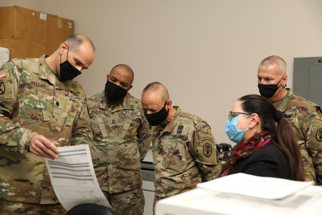 From left, Lt. Col. Gerald Kellar; Command Sgt. Maj. Abuoh Neufville, command sergeant major, Regional Health Command-Pacific; Brig. Gen. Jack M. Davis, commanding general, RHC-P; Milagros Sola, a microbiologist with PHC-P; and Lt. Col. Darren Harrison, commander of Public Health Activity-Fort Lewis, examine pooled testing results at PHC-P’s new COVID-19 Surveillance Testing Laboratory at Joint Base Lewis-McChord, Washington, Dec. 3, 2020. (U.S. Army photo by Christopher Larsen, RHC-P Public Affairs)