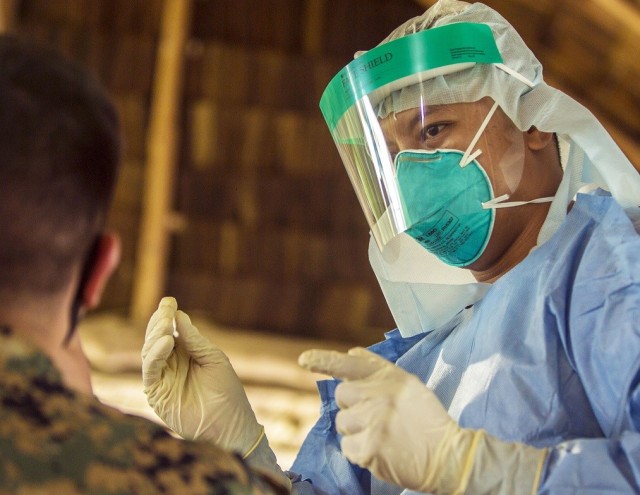 An employee of the Palau Ministry of Health conducts a COVID-19 test on a Marine assigned to the Task Force Koa Moana 20, I Marine Expeditionary Force in Peleliu, Republic of Palau, Aug. 5, 2020. Marines and sailors with TF KM20, are conducting...