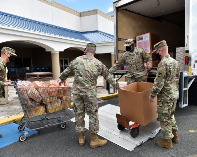 Fort Buchanan Religious Support Office (RSO) Command Chaplain, Maj. Keller, RSO NCO Sgt. 1st Class Spann, Garrison Commander Col. Corcoran and Garrison Command Sgt. Maj. Banks load up 600 pounds of food donated by garrison personnel, tenants and...