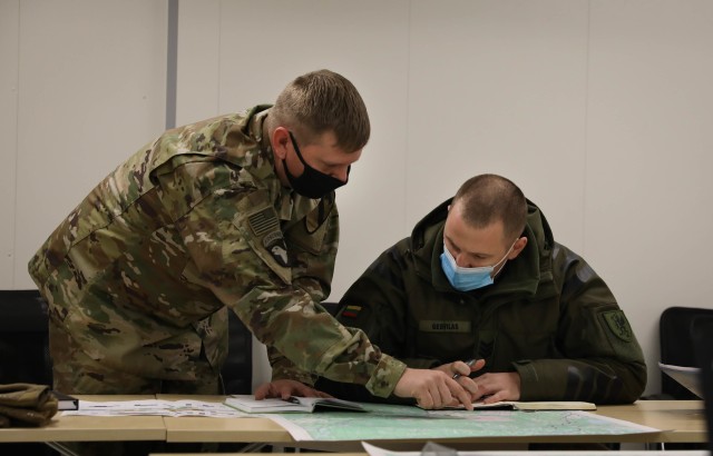 Stallion Bradley Master Gunner Staff Sgt. Christopher Ledwell coordinates resources with his Lithuanian counterpart Staff Sgt. Darius Gedvilas, Griffin Brigade G3, during a Dec. 4, 2020 meet and greet at the Pabrade Training Area. During the...