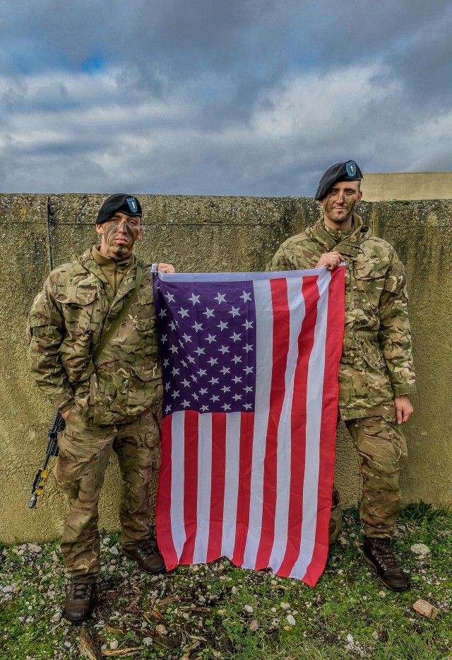 FORT BENNING, Ga. – Two U.S. Army officers attending Britain's Royal Military Academy Sandhurst this year, pose with the American flag. The officers, 2nd Lt. Elijah M. Villapiano (left), and 2nd Lt. Alexander Nappi, were selected for...