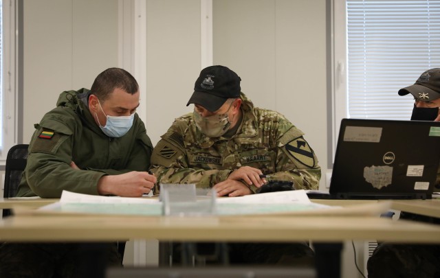 Lithuanian Motorized Infantry “Griffin” Brigade Chief of Staff Lt. Col. Vadimas Jeriominas coordinated future live-fire training events with allied 2nd Battalion, 8th Cavalry Regiment “Stallions” Commander Lt. Col. Steven Jackowski during...