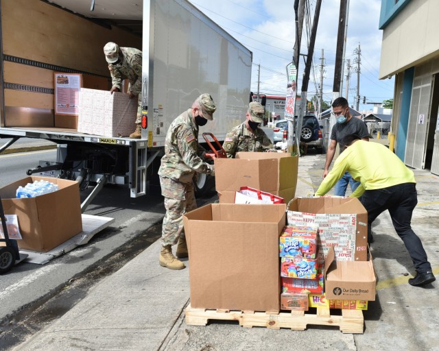 Fort Buchanan Religious Support Office (RSO) Command Chaplain, Maj. Keller, RSO NCO Sgt. 1st Class Spann, Garrison Commander Col. Corcoran and Garrison Command Sgt. Maj. Banks un-load over 600 pounds of food delivered to Bill’s Kitchen, donated...