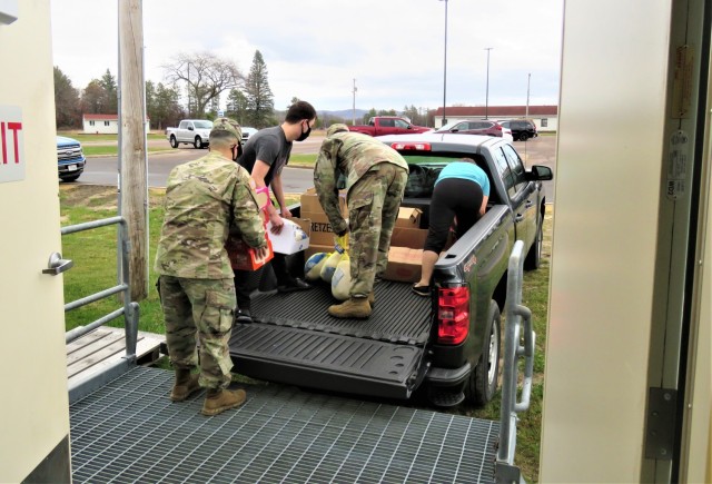 Fort McCoy, Wis., employees and Soldiers load donated food to be taken to food pantries in Sparta and Tomah, Wis., on Nov. 9, 2020, at the installation. The effort was part of a holiday food drive by Headquarters and Headquarters Company, U.S....