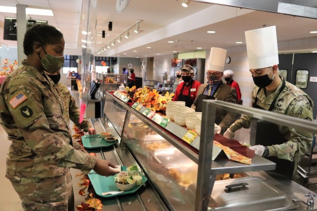 Soldiers receive plates of food during the annual Fort McCoy Thanksgiving meal Nov. 19, 2020, at the Noncommissioned Officer Academy Dining Facility on the cantonment area at Fort McCoy, Wis. The meal included all the traditional Thanksgiving...