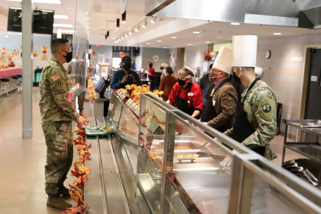 Soldiers receive plates of food during the annual Fort McCoy Thanksgiving meal Nov. 19, 2020, at the Noncommissioned Officer Academy Dining Facility on the cantonment area at Fort McCoy, Wis. The meal included all the traditional Thanksgiving...
