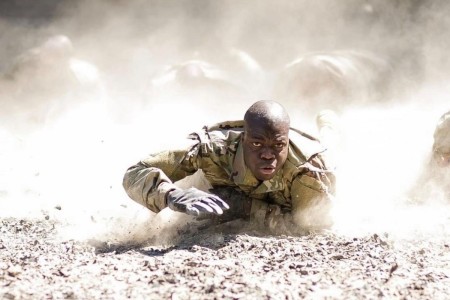 A determined trainee low crawls through the dust as he makes his way through the &#34;Team Week&#34; confidence course during Basic Combat Training on Fort Jackson, S.C.