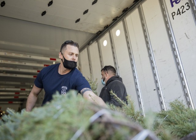 Guard members load holiday trees for military families