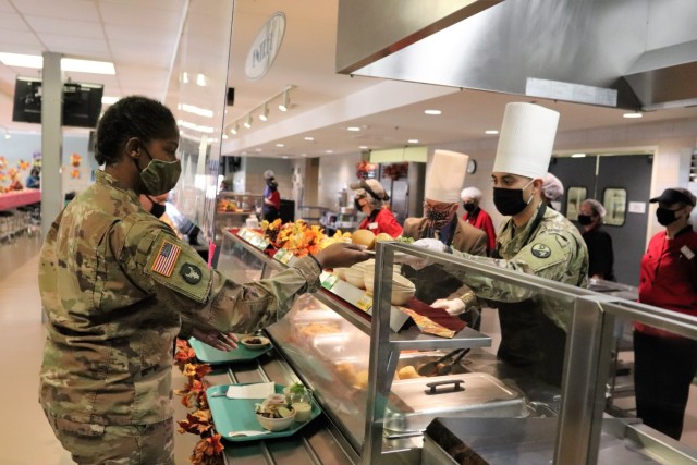 Soldiers receive plates of food during the annual Fort McCoy Thanksgiving meal Nov. 19, 2020, at the Noncommissioned Officer Academy Dining Facility on the cantonment area at Fort McCoy, Wis. The meal included all the traditional Thanksgiving...