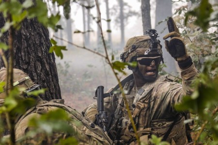 A Soldier signals his team toward the breach point during a live-fire exercise at Fort Polk, La., Oct. 27, 2020. 