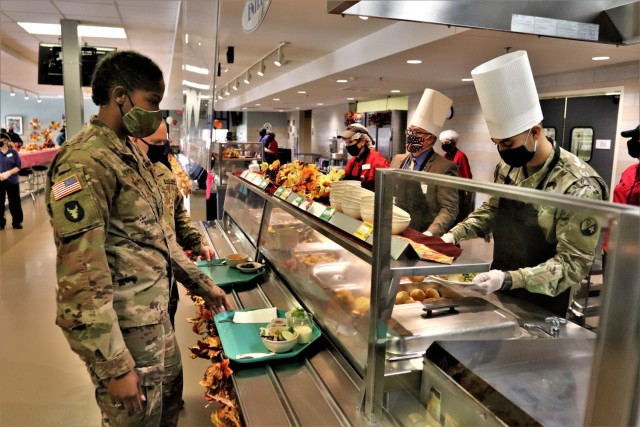 Soldiers receive plates of food during the annual Fort McCoy Thanksgiving meal Nov. 19, 2020, at the Noncommissioned Officer Academy Dining Facility on the cantonment area at Fort McCoy, Wis. The meal included all the traditional Thanksgiving...
