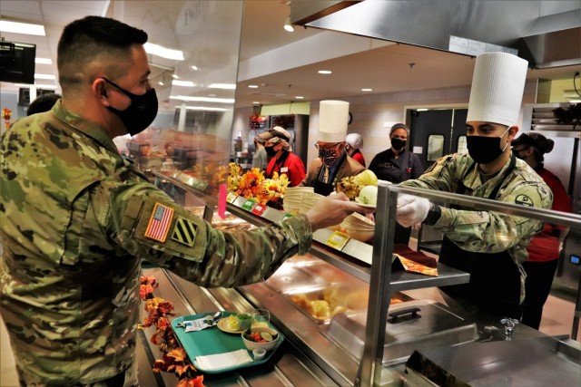 Soldiers receive plates of food during the annual Fort McCoy Thanksgiving meal Nov. 19, 2020, at the Noncommissioned Officer Academy Dining Facility on the cantonment area at Fort McCoy, Wis. The meal included all the traditional Thanksgiving...