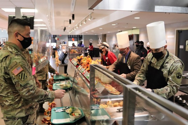 Soldiers receive plates of food during the annual Fort McCoy Thanksgiving meal Nov. 19, 2020, at the Noncommissioned Officer Academy Dining Facility on the cantonment area at Fort McCoy, Wis. The meal included all the traditional Thanksgiving...
