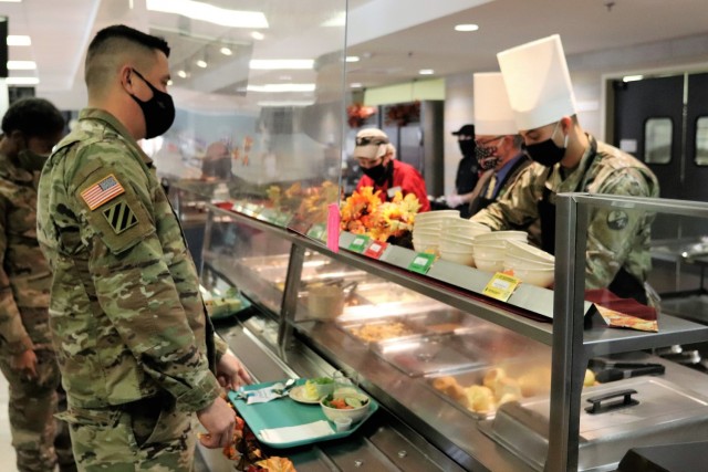 Soldiers receive plates of food during the annual Fort McCoy Thanksgiving meal Nov. 19, 2020, at the Noncommissioned Officer Academy Dining Facility on the cantonment area at Fort McCoy, Wis. The meal included all the traditional Thanksgiving...