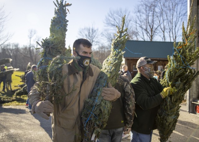 Guard members load holiday trees for military families