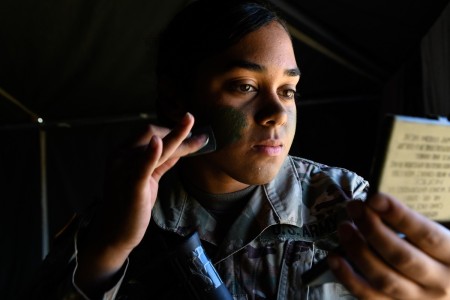 Spc. Tynina Williams applies face paint prior to mission during the U.S. Army Europe European Best Warrior Competition at U.S. Army Garrison Hohenfels Training Area, Germany, July 29, 2020.