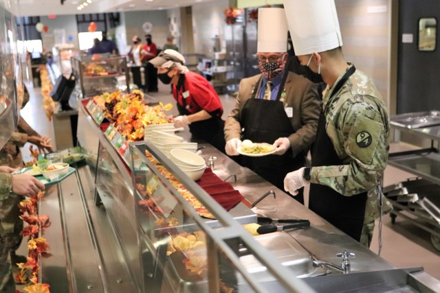 Soldiers receive plates of food during the annual Fort McCoy Thanksgiving meal Nov. 19, 2020, at the Noncommissioned Officer Academy Dining Facility on the cantonment area at Fort McCoy, Wis. The meal included all the traditional Thanksgiving...