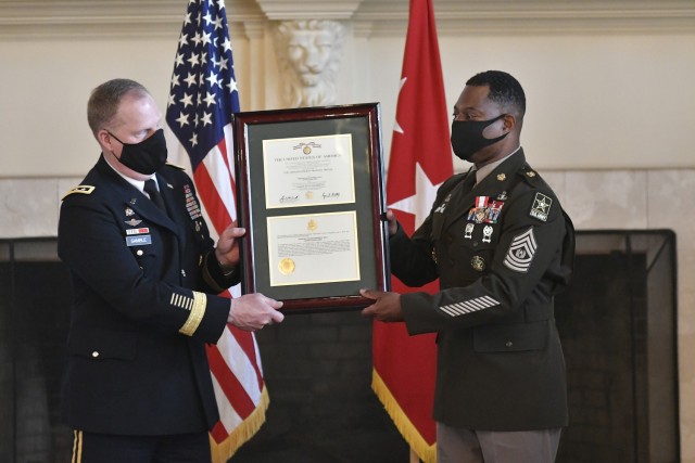 Lt. Gen. Duane A. Gamble, Deputy Chief of Staff, G-4, presents the Distinguished Service Medal award certificate to Sgt. Maj. Edward A. Bell, his departing sergeant major, during a retirement ceremony Sept. 18 in the Lee Club. Bell, who spend 21 years at Fort Bragg, N.C., concluded 33 years of military service.