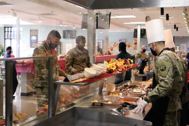 Soldiers receive plates of food during the annual Fort McCoy Thanksgiving meal Nov. 19, 2020, at the Noncommissioned Officer Academy Dining Facility on the cantonment area at Fort McCoy, Wis. The meal included all the traditional Thanksgiving...