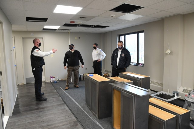 Fort Drum Directorate of Emergency Services officials review the progress made during the renovation of Fire Station No. 1 on post Dec. 1. (Photo by Mike Strasser, Fort Drum Garrison Public Affairs)